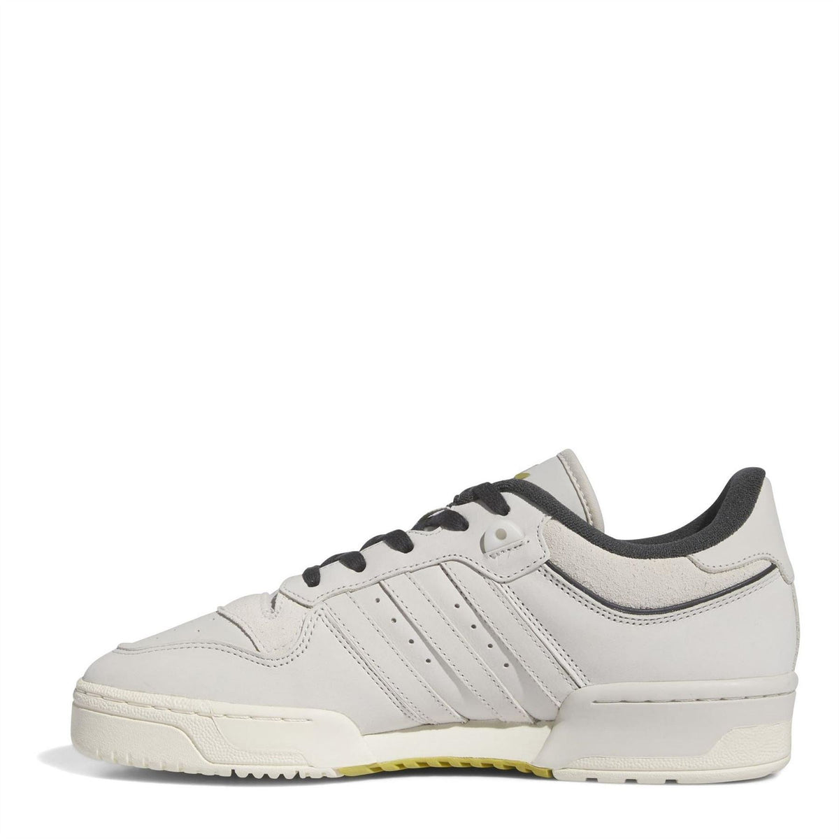 White low-top sneakers with side stripes, black lace-up, and rubber cupsole
