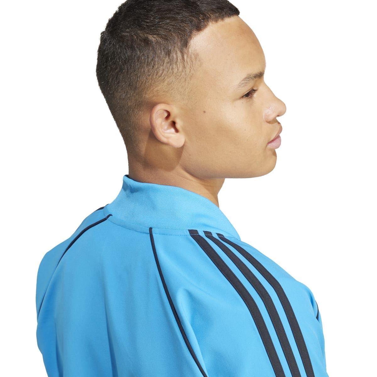 Blue adidas track jacket close-up of high collar and black triple shoulder stripes