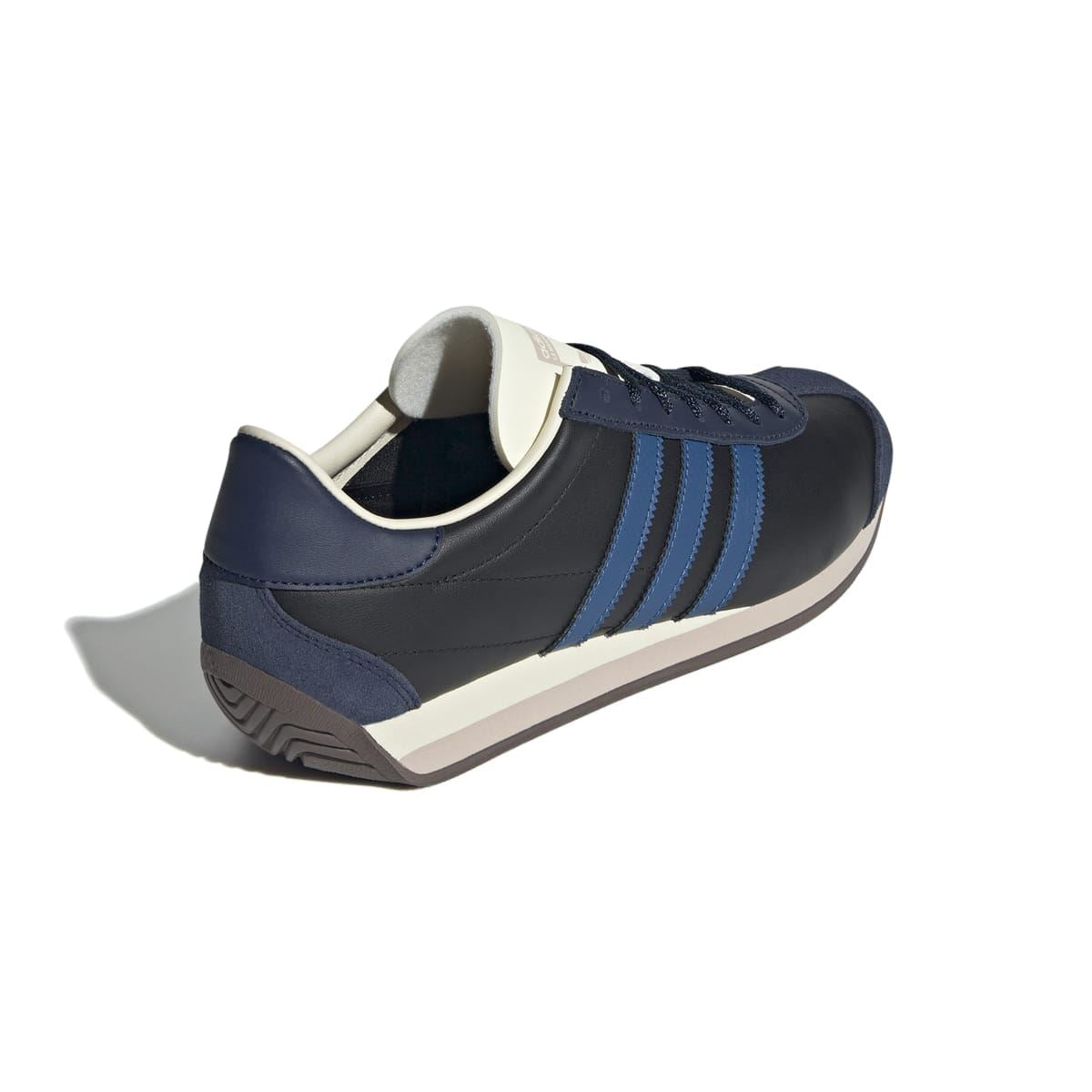 Back three-quarter view of navy/black trainer with blue stripes and cream heel collar