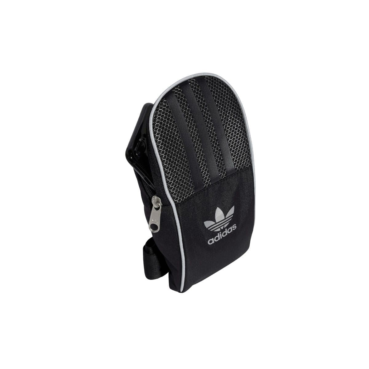 Black adidas small item bag with crossbody strap, zip top, trefoil logo patch.