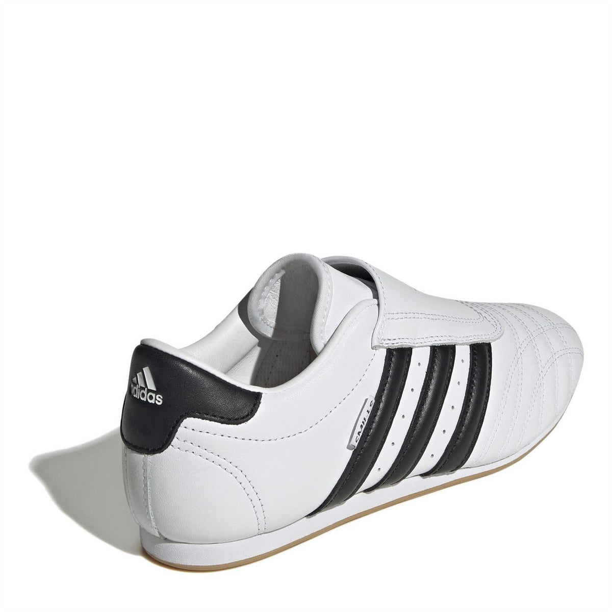 White low-top trainers with black stripe accents and adidas heel logo patch