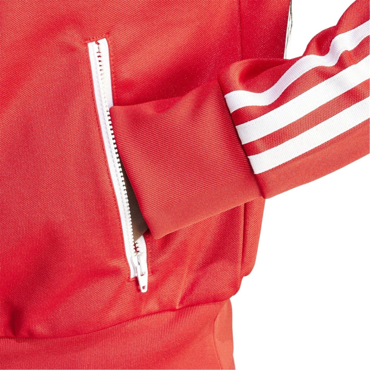 Red athletic top detail with front half-zip and visible zipper pull.