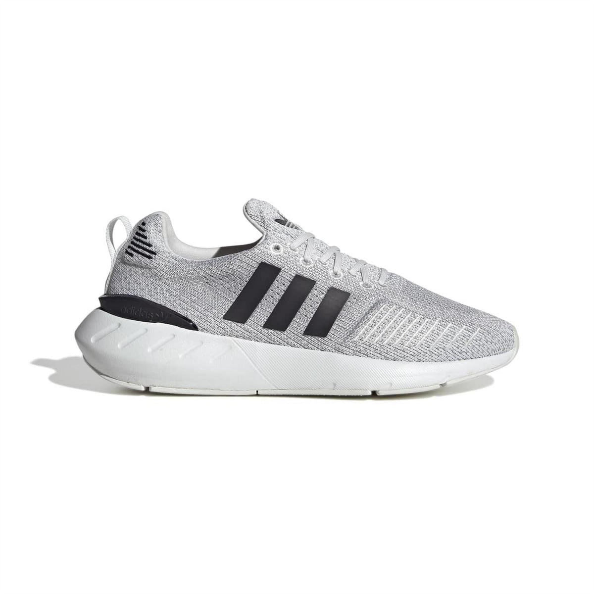 Grey knit adidas Originals trainers with black stripes and white cushioned sole.