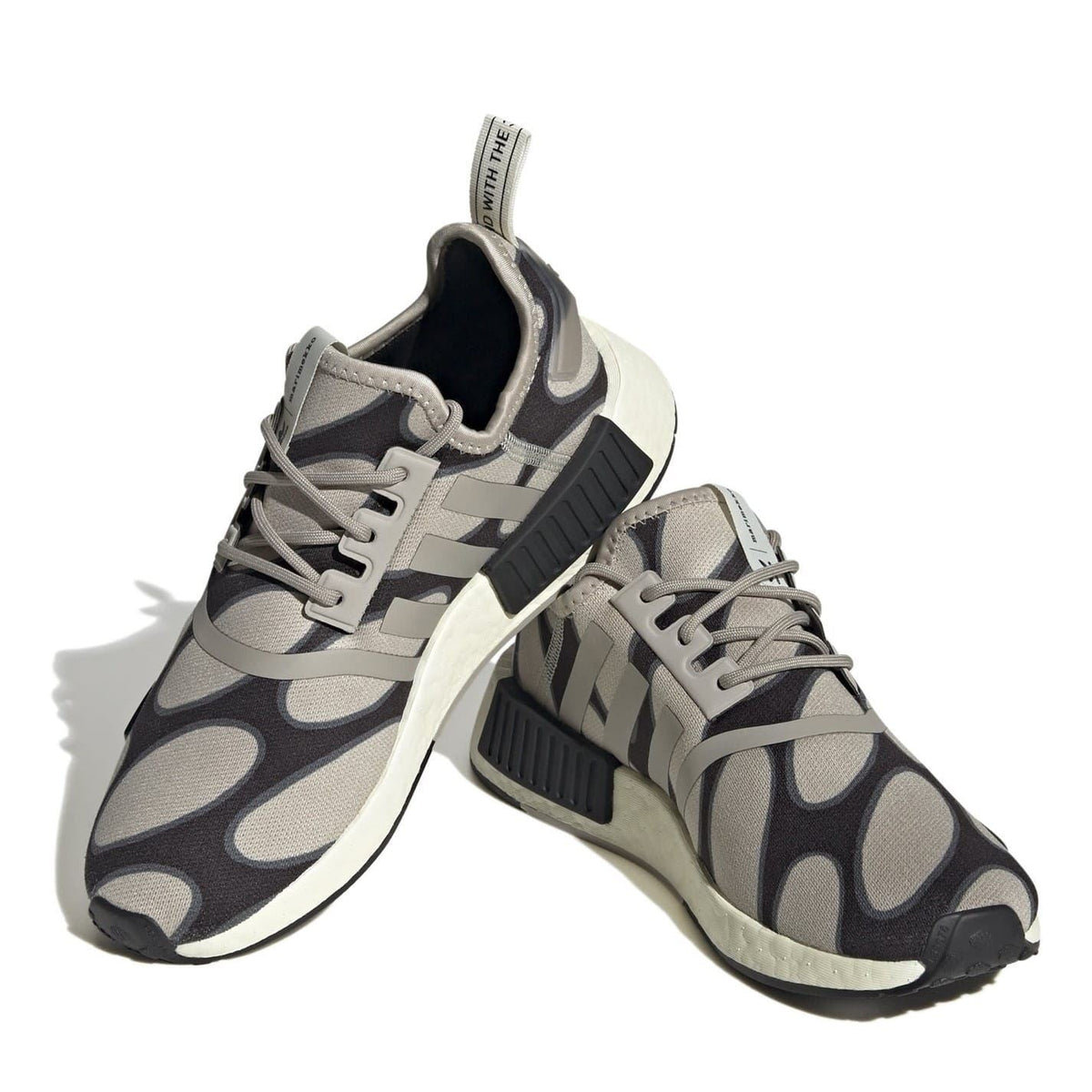 adidas Originals NMD R1 low top sneakers in black with white Boost sole, showcasing sleek sporty footwear design