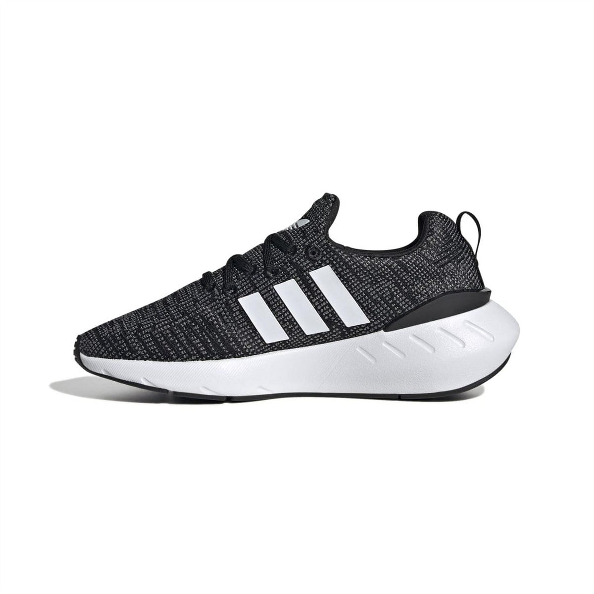 Black knit low-top trainers with white 3-stripe band, laces, and chunky white midsole