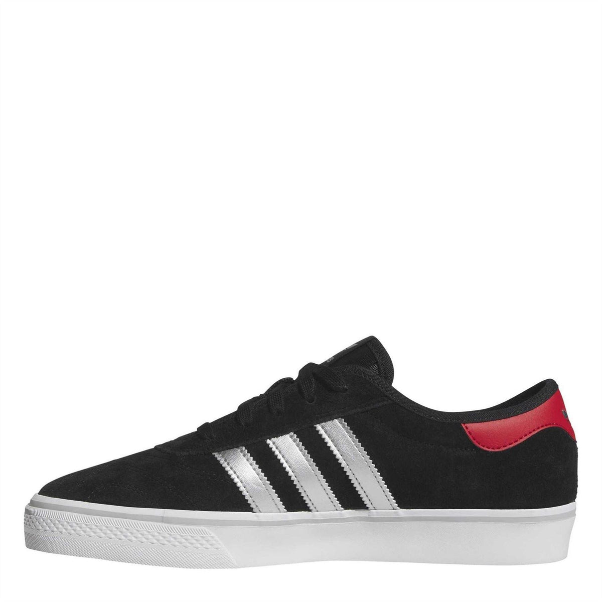 Black suede low-top sneaker side view with white stripes and red collar detail, lace-up.