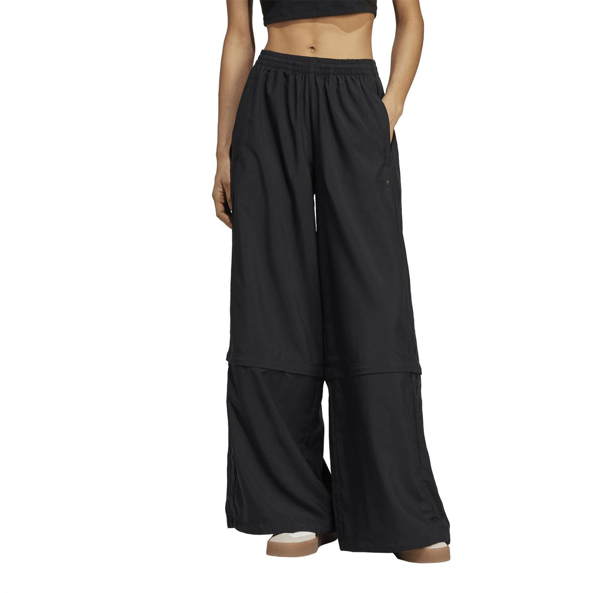 Black wide-leg track pants with elastic waistband and long relaxed legs.