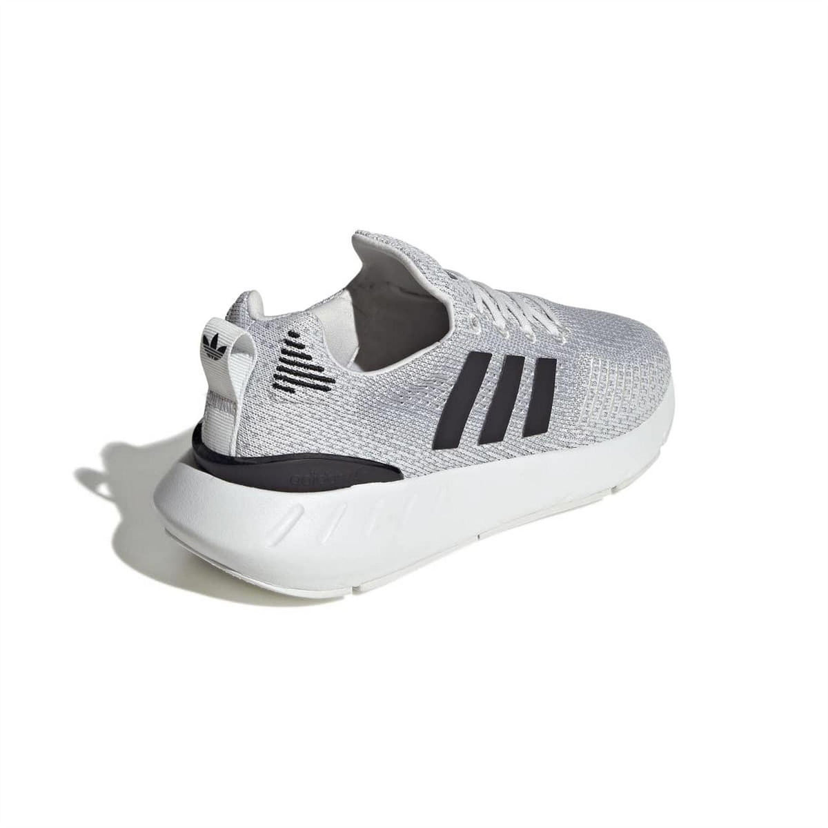 Grey adidas lace-up trainers with black stripes and white midsole, rear-side view.
