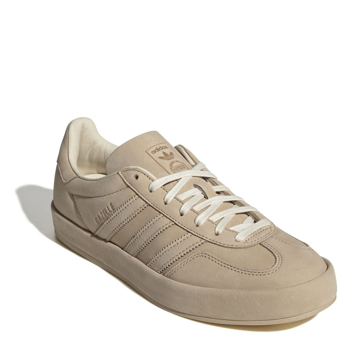Beige suede lace-up low-top sneakers with cushioned collar and lace-up eyelets