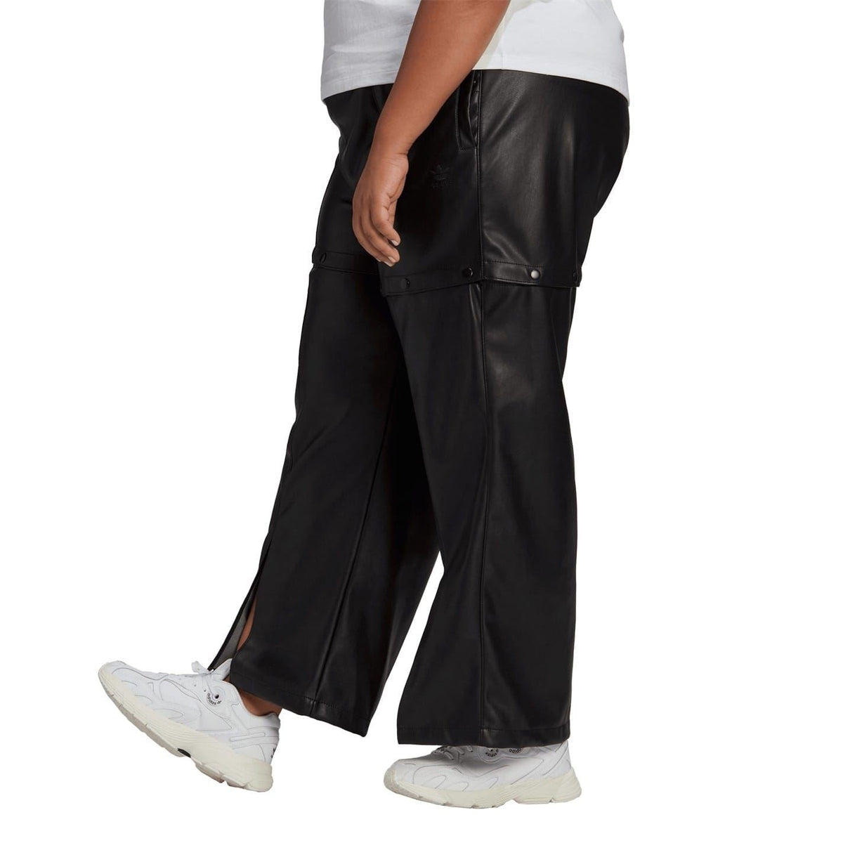 Black adidas Originals track pants with side button tabs and relaxed leg openings