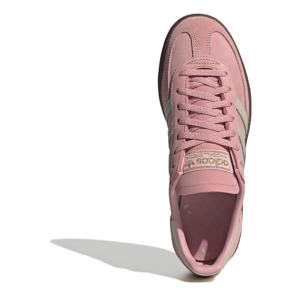 Pink suede low-top sneakers with lace-up front and adidas logo patch