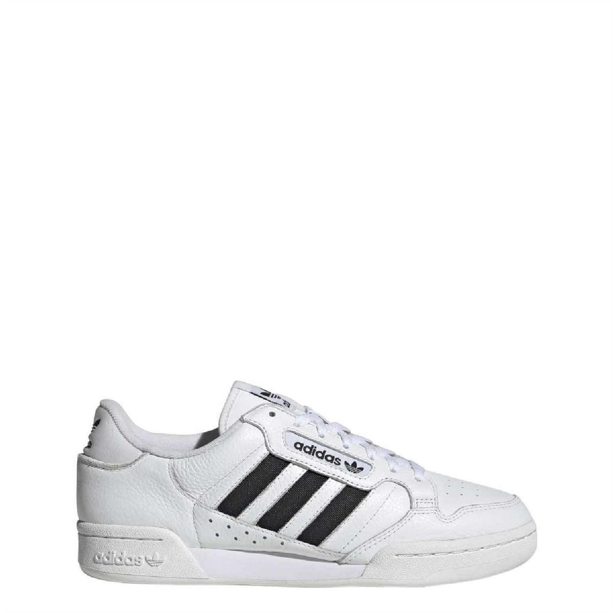 White adidas low-top trainers, side view with black three stripes and lace-up design