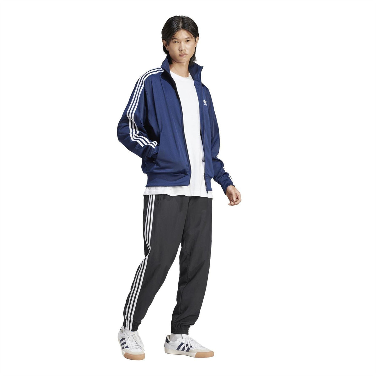 Men's indigo adidas track jacket with white triple stripes and full zip worn