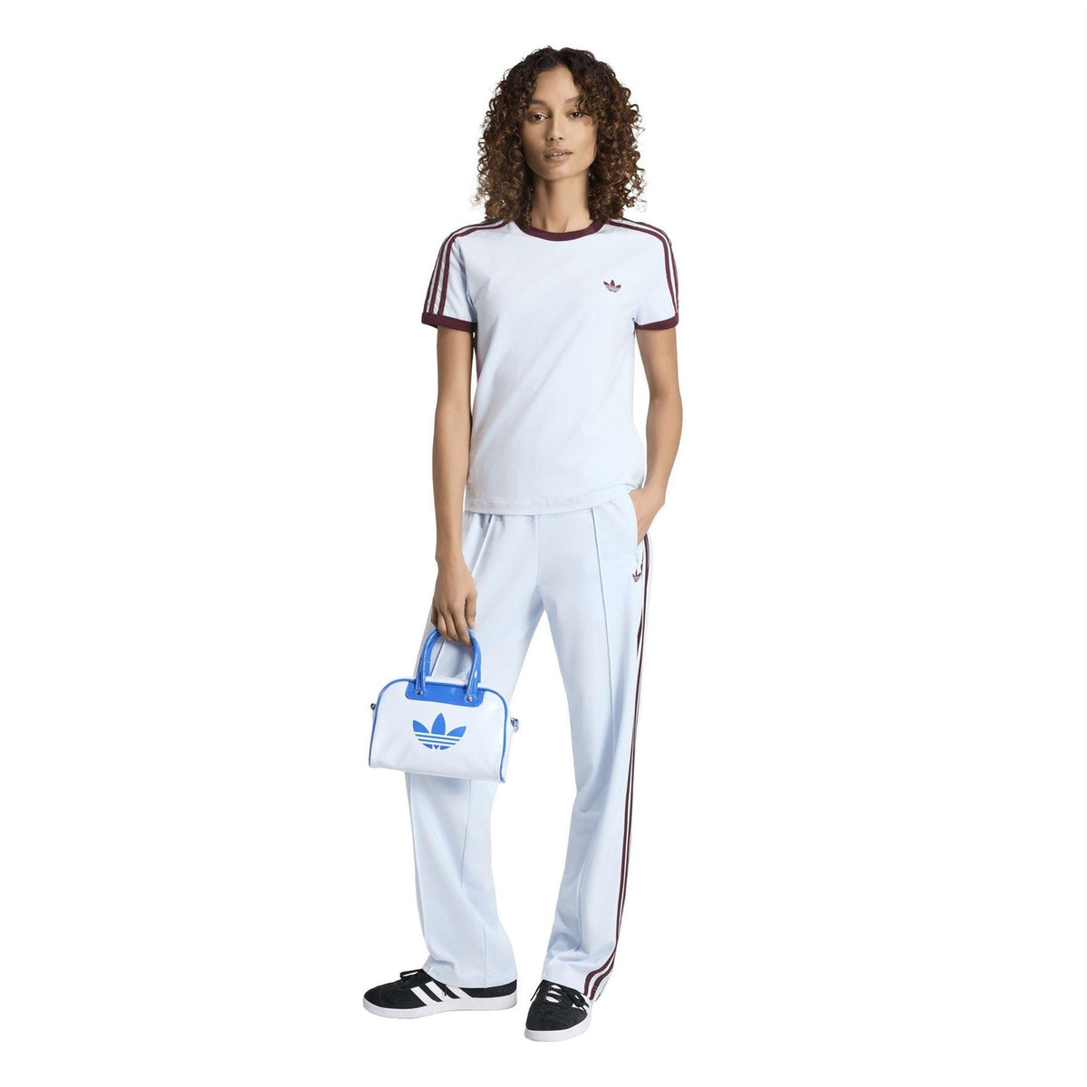 Womens white Firebird-style joggers with maroon stripes and trefoil emblem