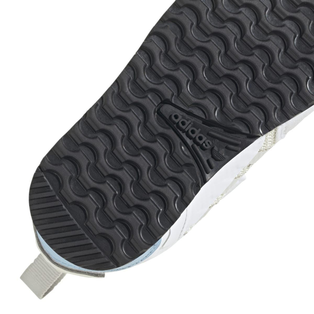 Infant trainer bottom view with dark tread lugs and adidas logo on the outsole