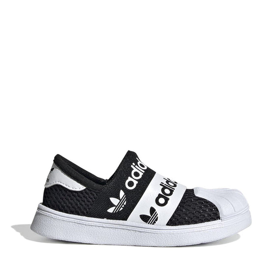 Black and white low-top sneakers with adidas logo straps and hook-and-loop closure