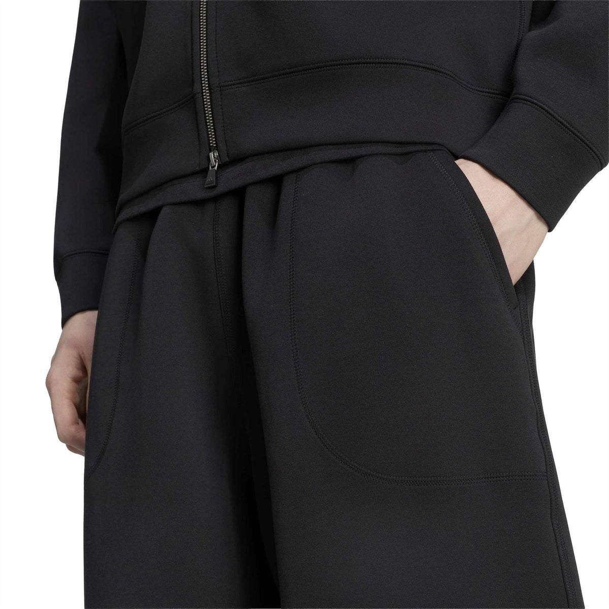 Black EQT pants with front pleats, side seam pockets, and curved pocket stitching