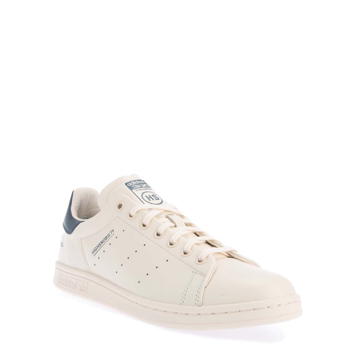 White high-top sneakers with navy heel collar and lace-up design, side profile view.