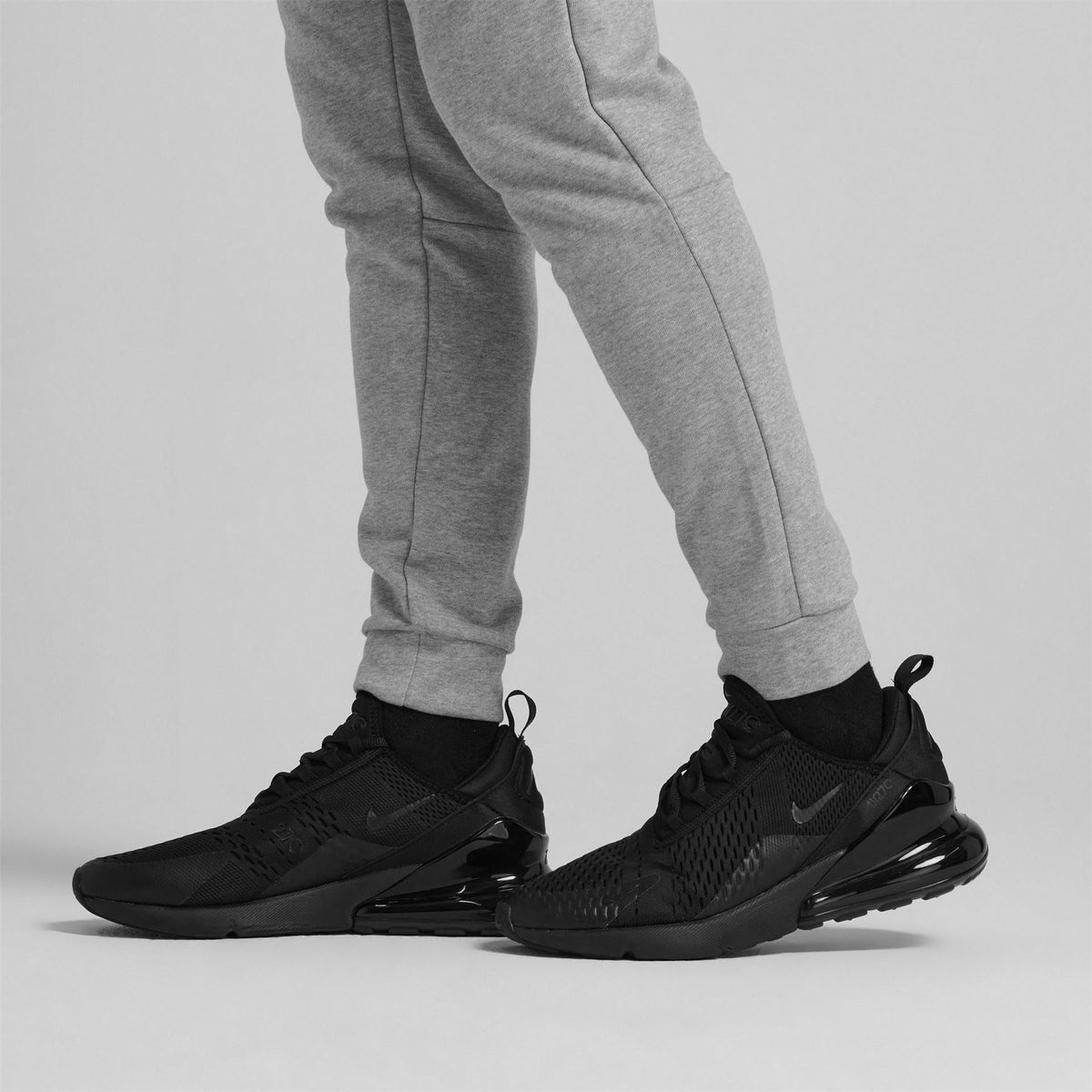 Men's Nike Air Max 270 trainers in black worn with grey sweatpants