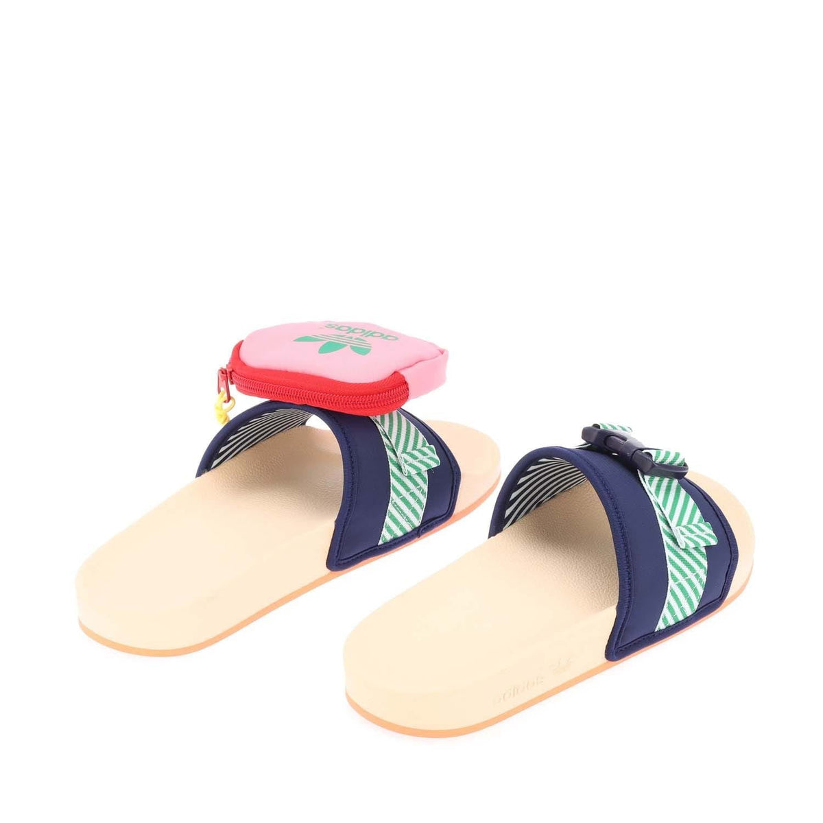Pair of navy slide sandals with green striped straps and pink zip pouch