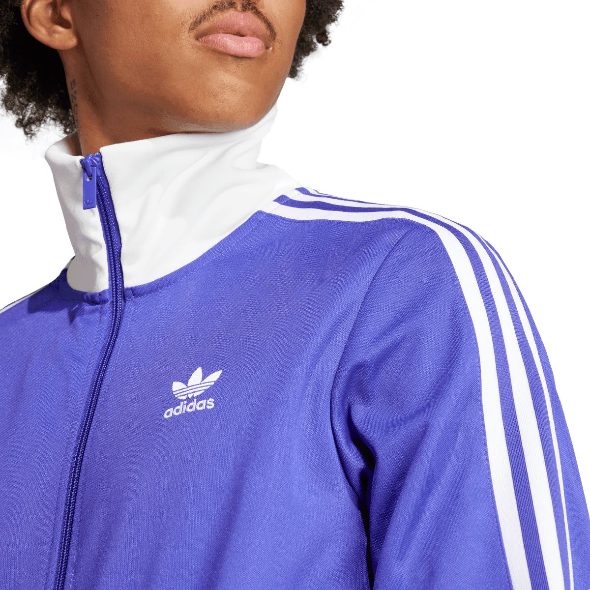 Close-up of purple adidas track top collar and zipper with white trim and shoulder stripes