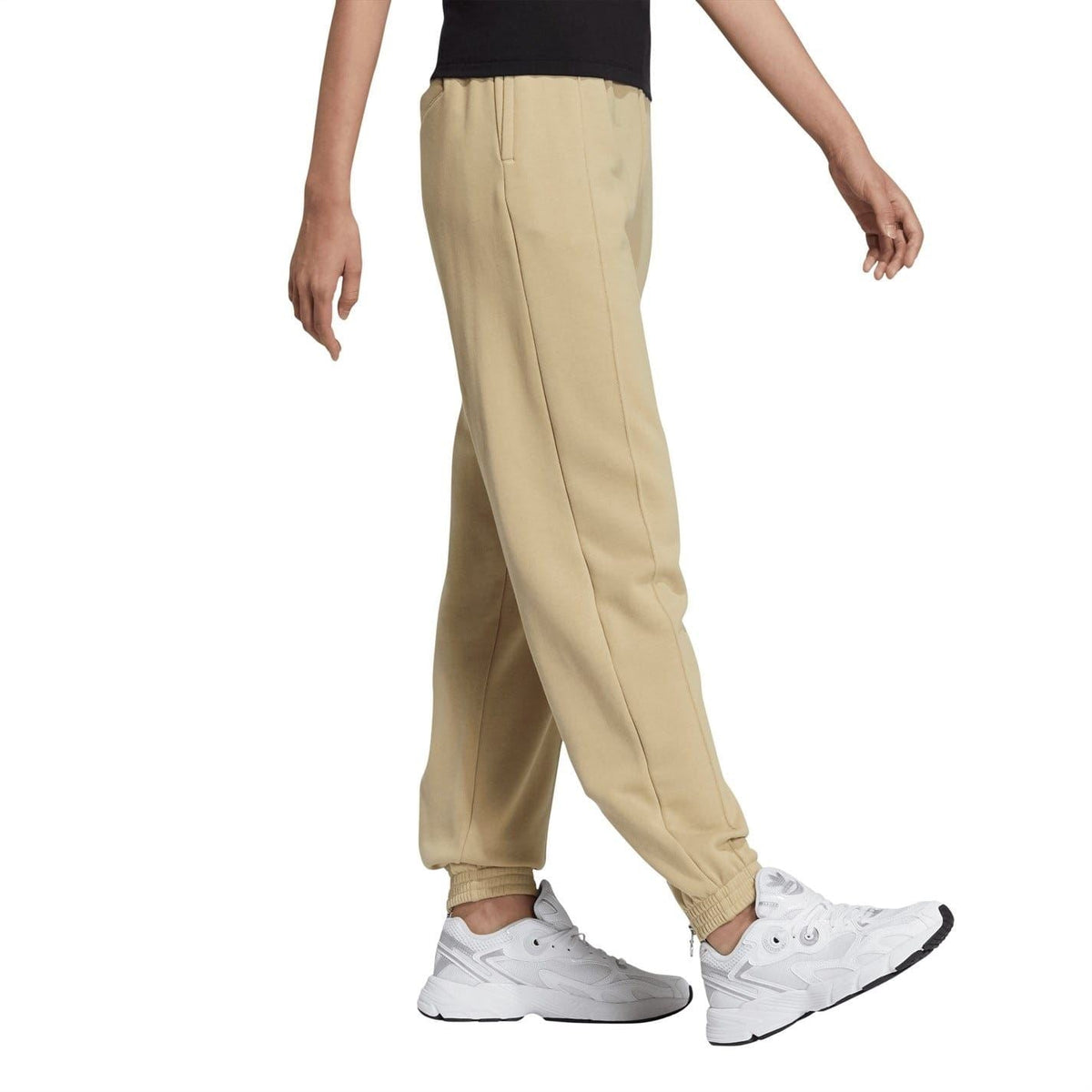 Beige adidas Originals sweatpants with elastic waistband and relaxed tapered fit