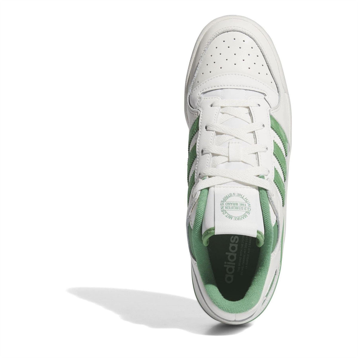 White adidas Originals low-top sneakers with green-striped laces and padded collar