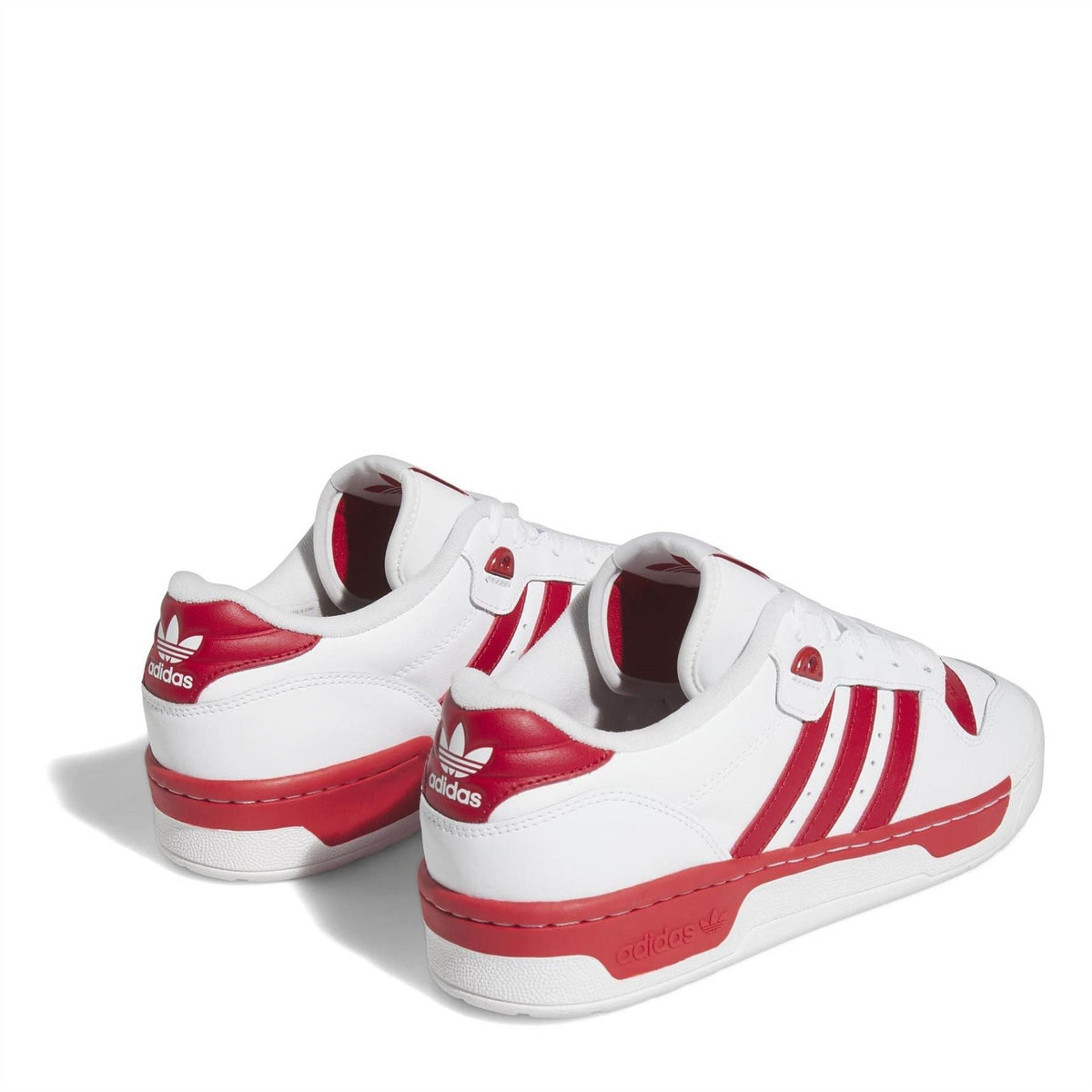 White adidas Originals Rivalry low-top trainers with red heel cups and side three-stripe design