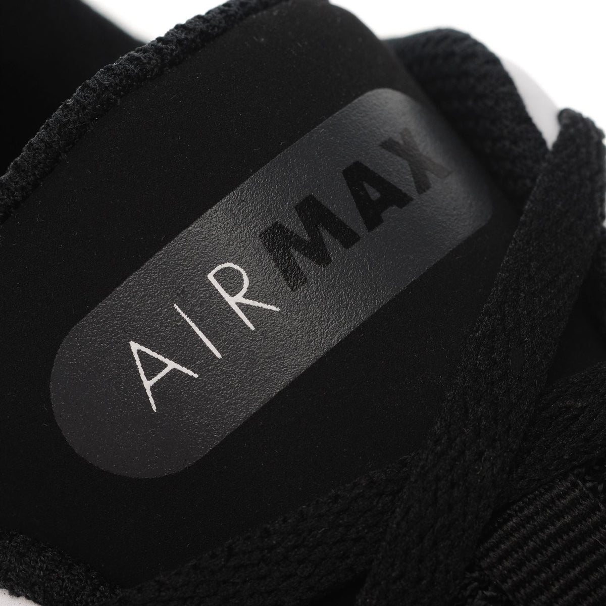Close-up of “AIRMAX” text on black insole of boys’ trainers