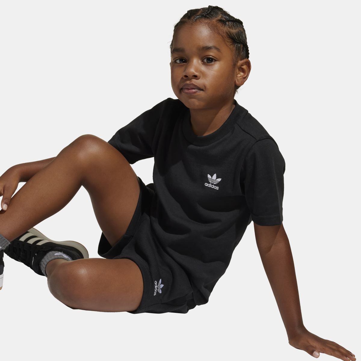 Black juniors T-shirt and shorts set in side pose, adidas logo visible