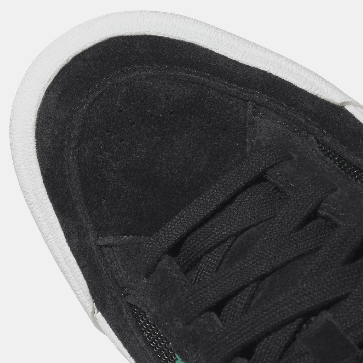 Close-up of black adidas Nora trainer upper with laces and adidas logo tag