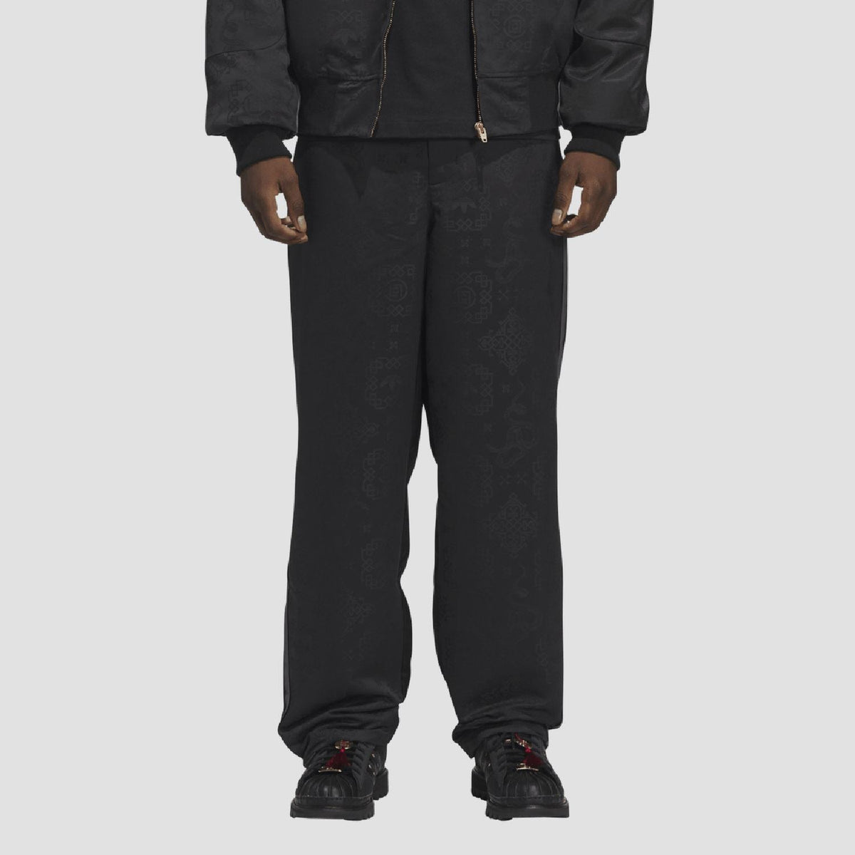 adidas Originals black tracksuit bottoms worn on model, ankle-length tapered cuffs