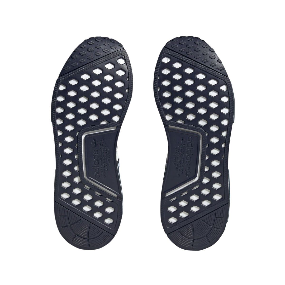 Navy adidas NMD R1 outsoles with white traction pods and black heel grip