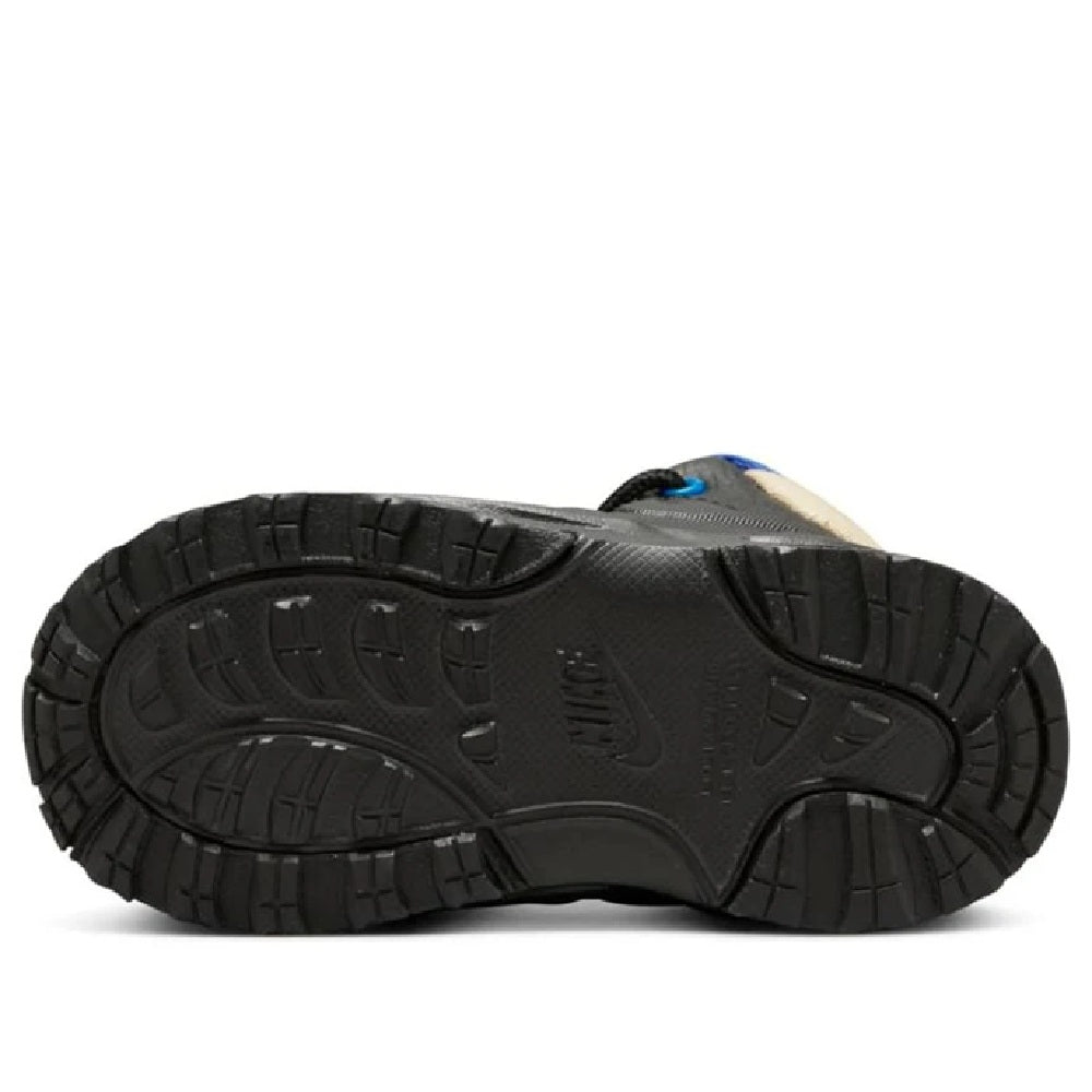 Kids Nike Manoa LTR outsole, black tread with blue detail near the toe