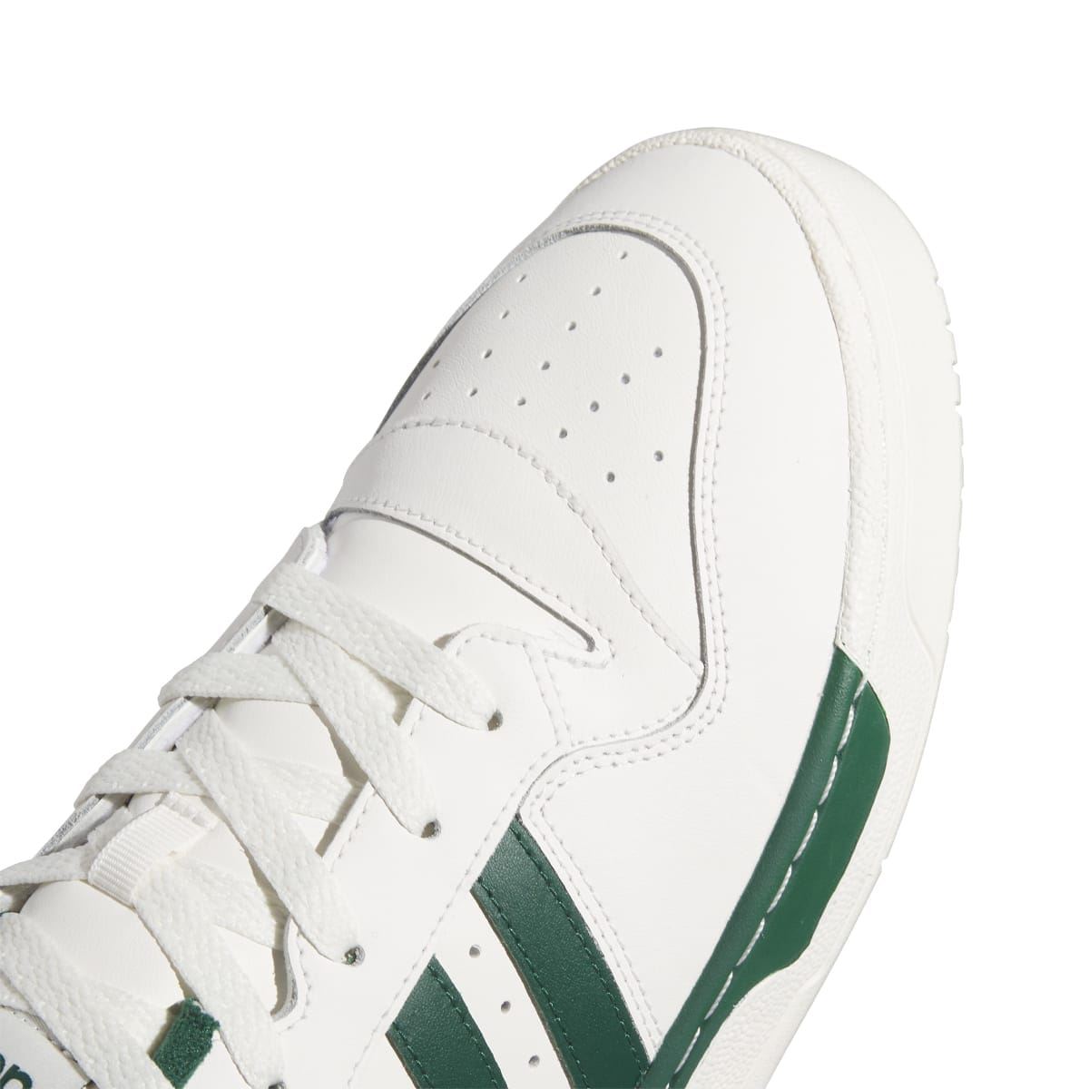 Close-up of adidas Rivalry Low upper: white leather with green stripe panel and laces