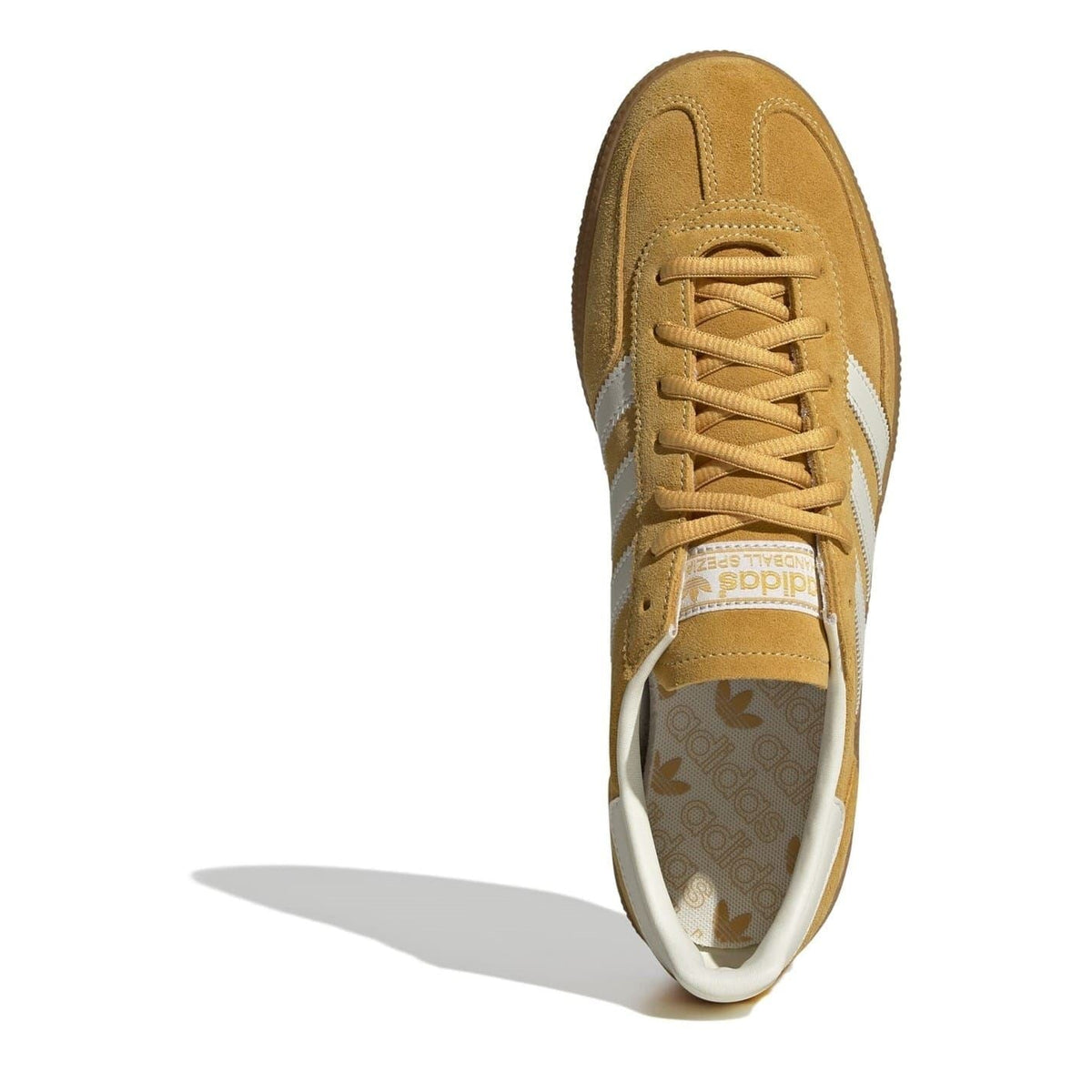 Tan suede low top sneaker with lace-up front and cushioned off-white collar.