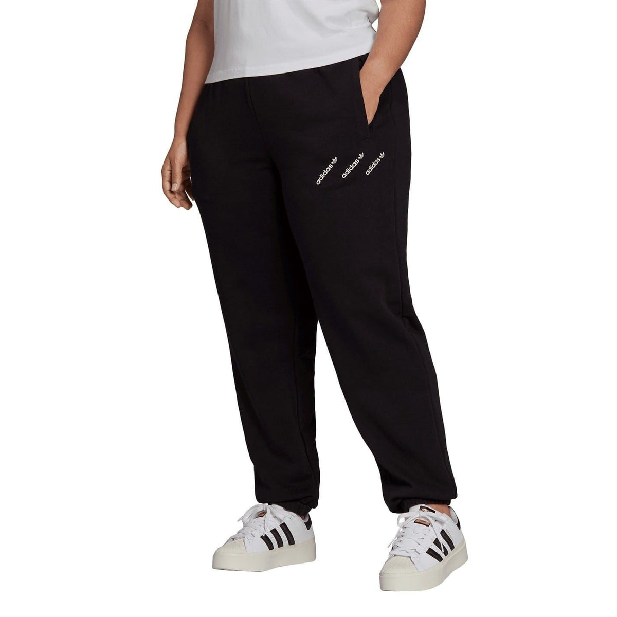 Black track sweatpants with adidas Originals side logo and cuffed hems
