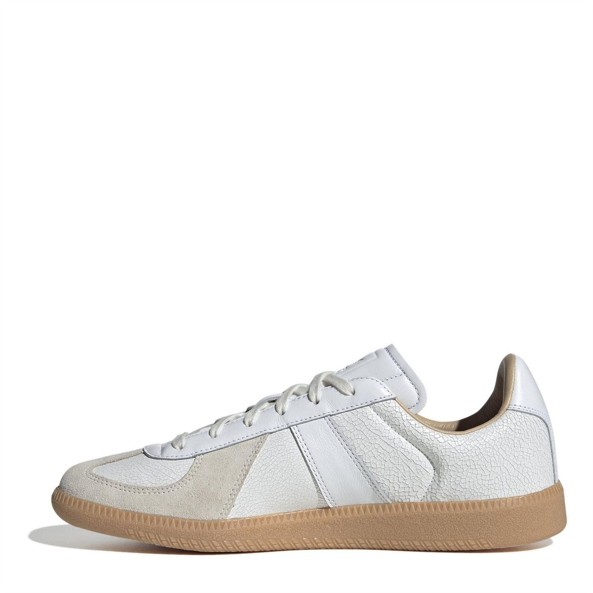 White and beige low-top adidas sneakers with lace-up front and textured gum outsole