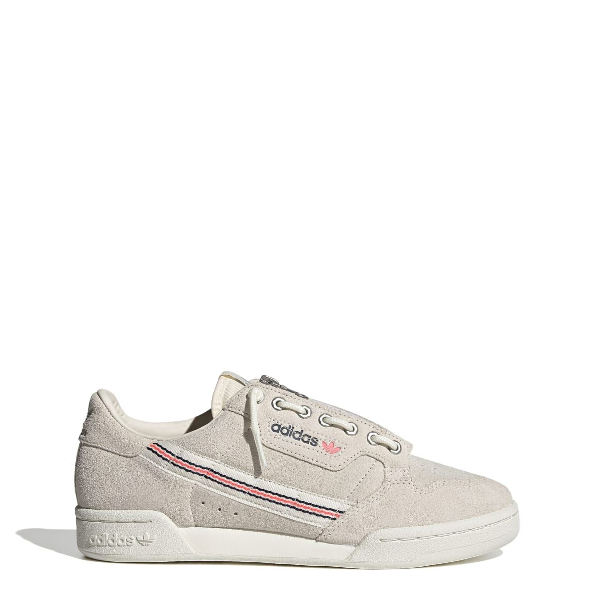 Light beige suede low-top sneakers with lace-up front, adidas branding, side stripe trim