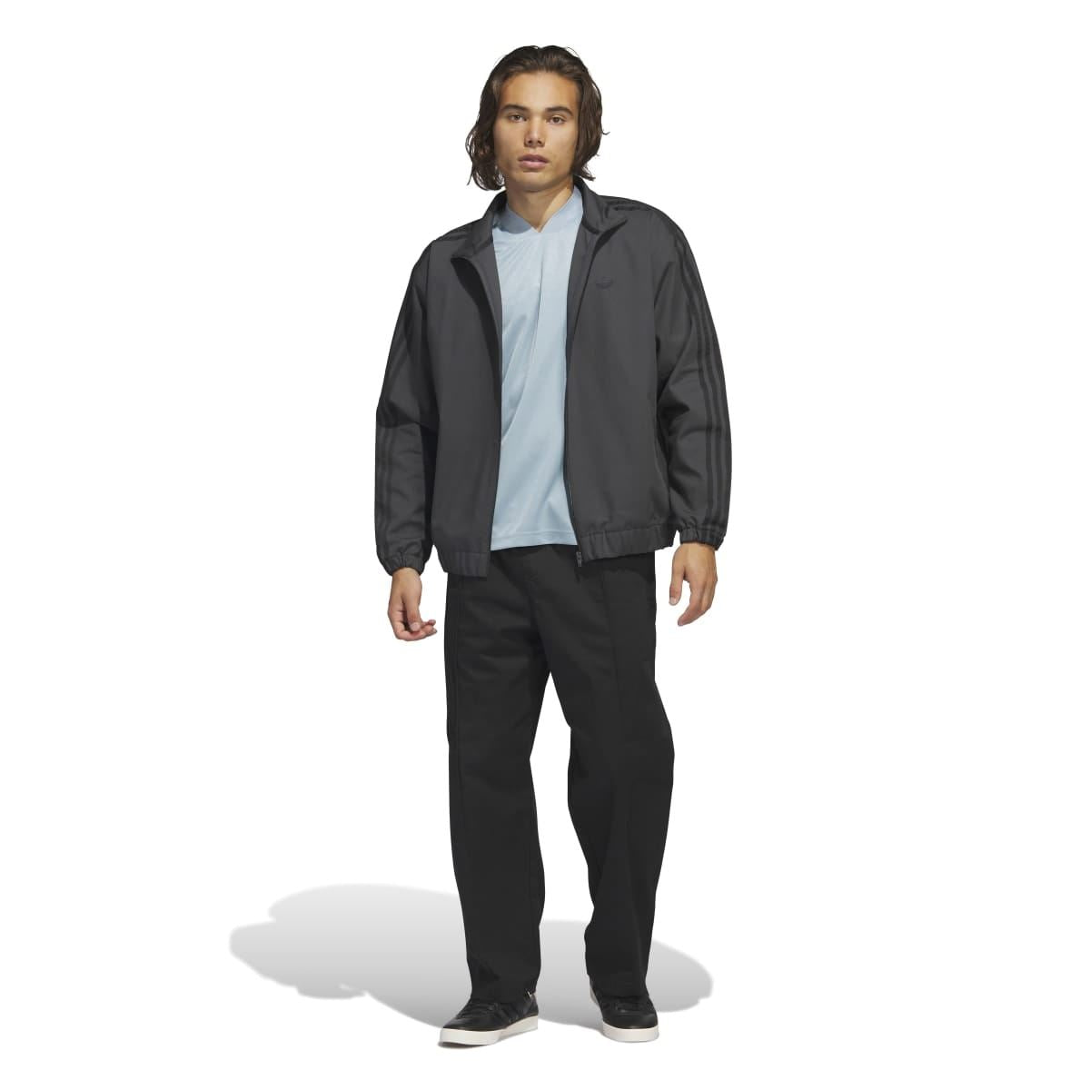 Light blue jersey T-shirt under black jacket; V-neck with trefoil logo