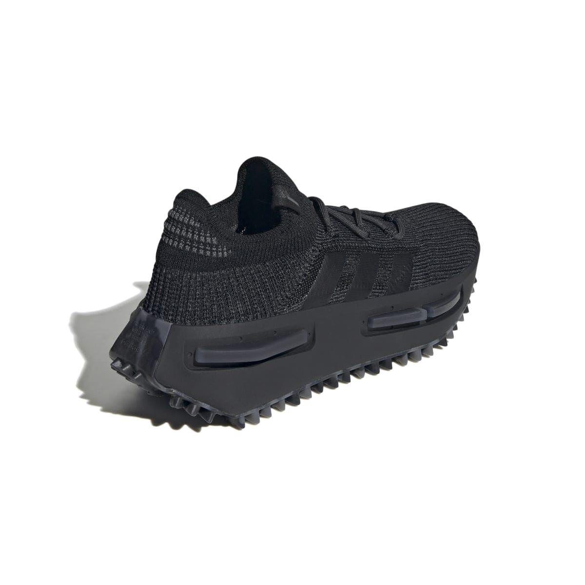 Black knit trainer with rear heel tab and chunky midsole with visible air pods