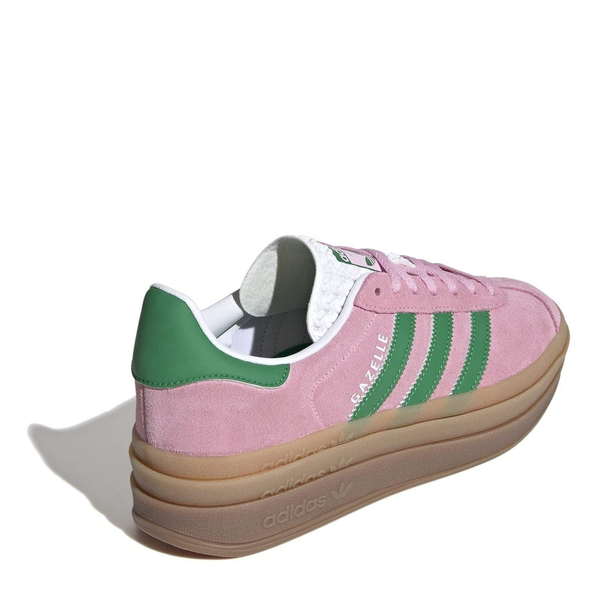 Pink suede low-top sneakers with green collar trim and gum outsole
