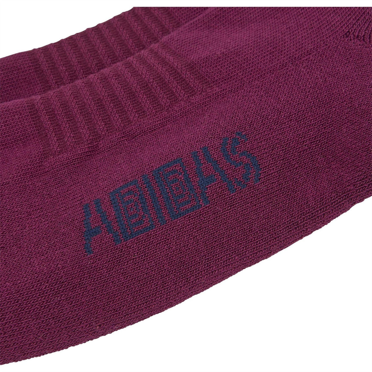 Maroon crew sock close-up with adidas logo and Brain Dead lettering