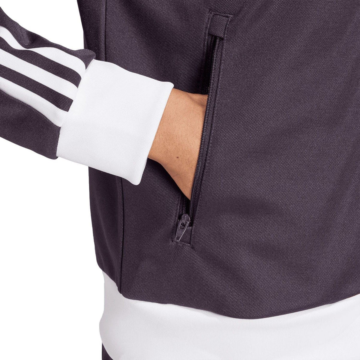 Dark purple track top close-up of full-zip front and zip pocket near the waist
