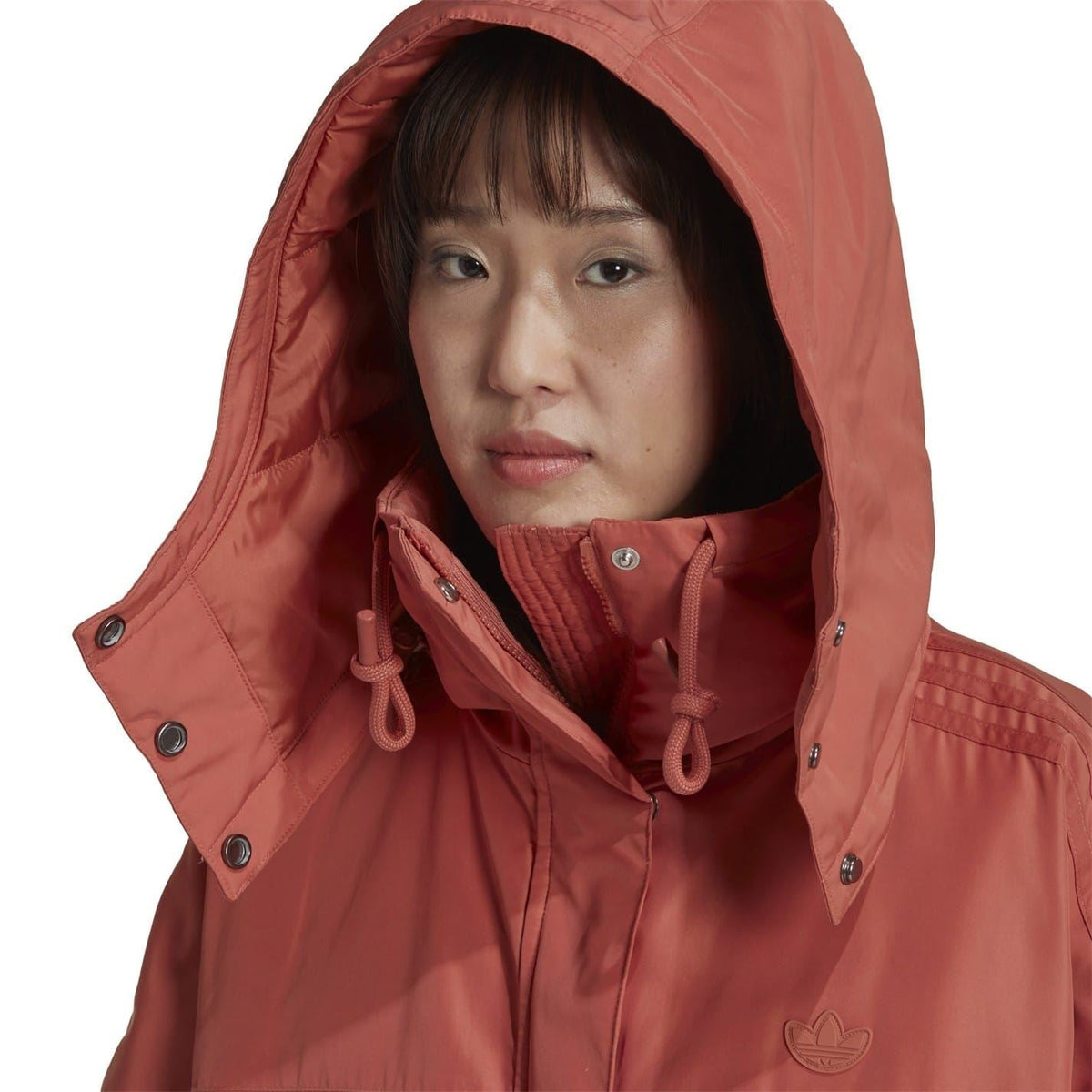 Burgundy hooded parka close-up with drawstring and adidas logo on chest.
