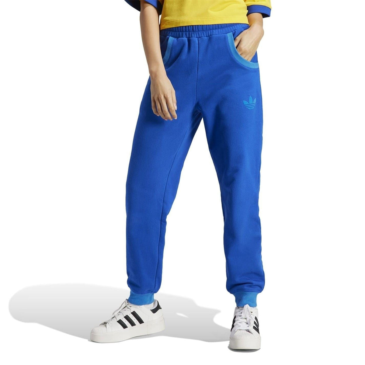 adidas Originals casual sweatpants with tapered fit, soft fabric, and signature logo, perfect for comfortable everyday wear