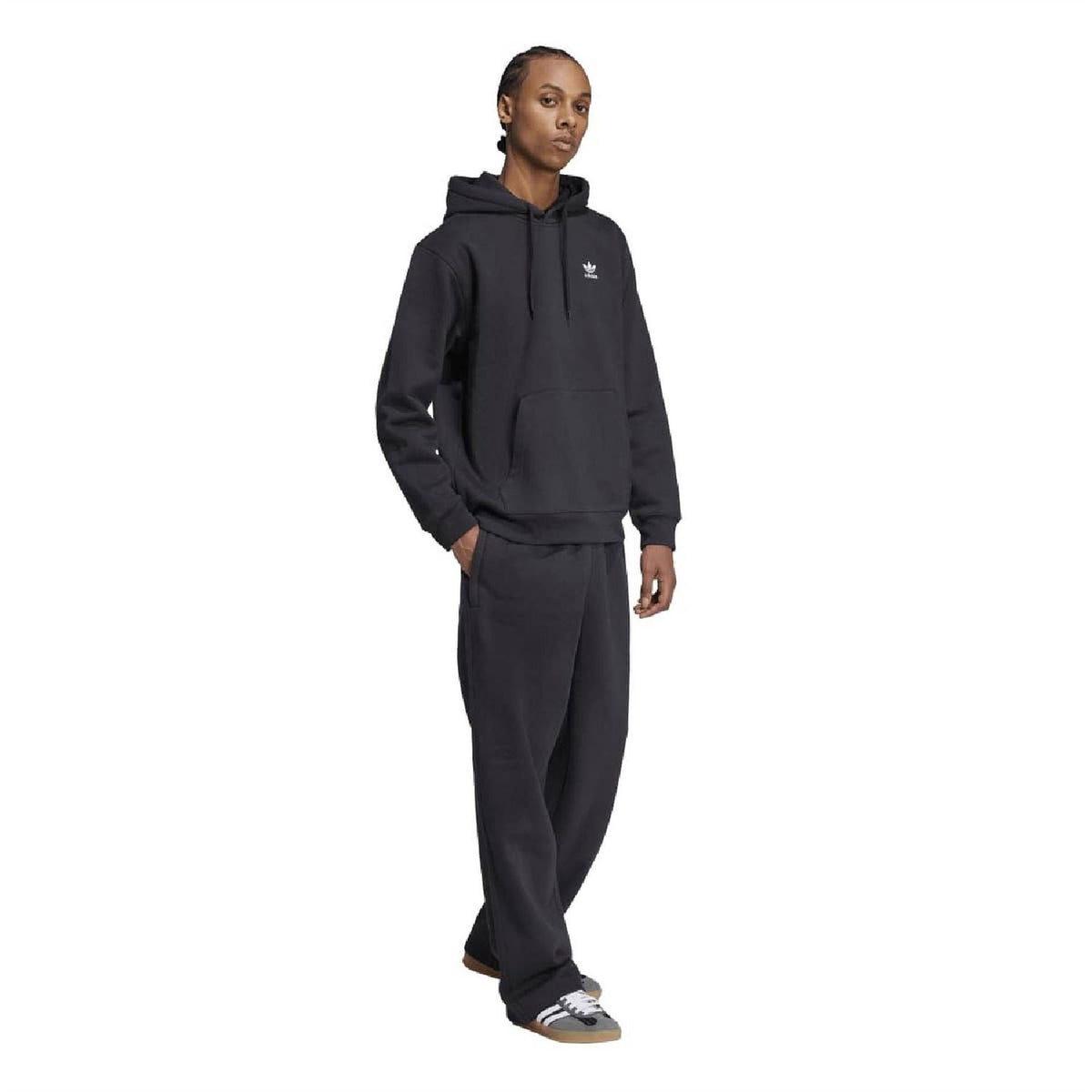 Black adidas Trefoil loose hoodie with drawstring hood, worn with matching pants