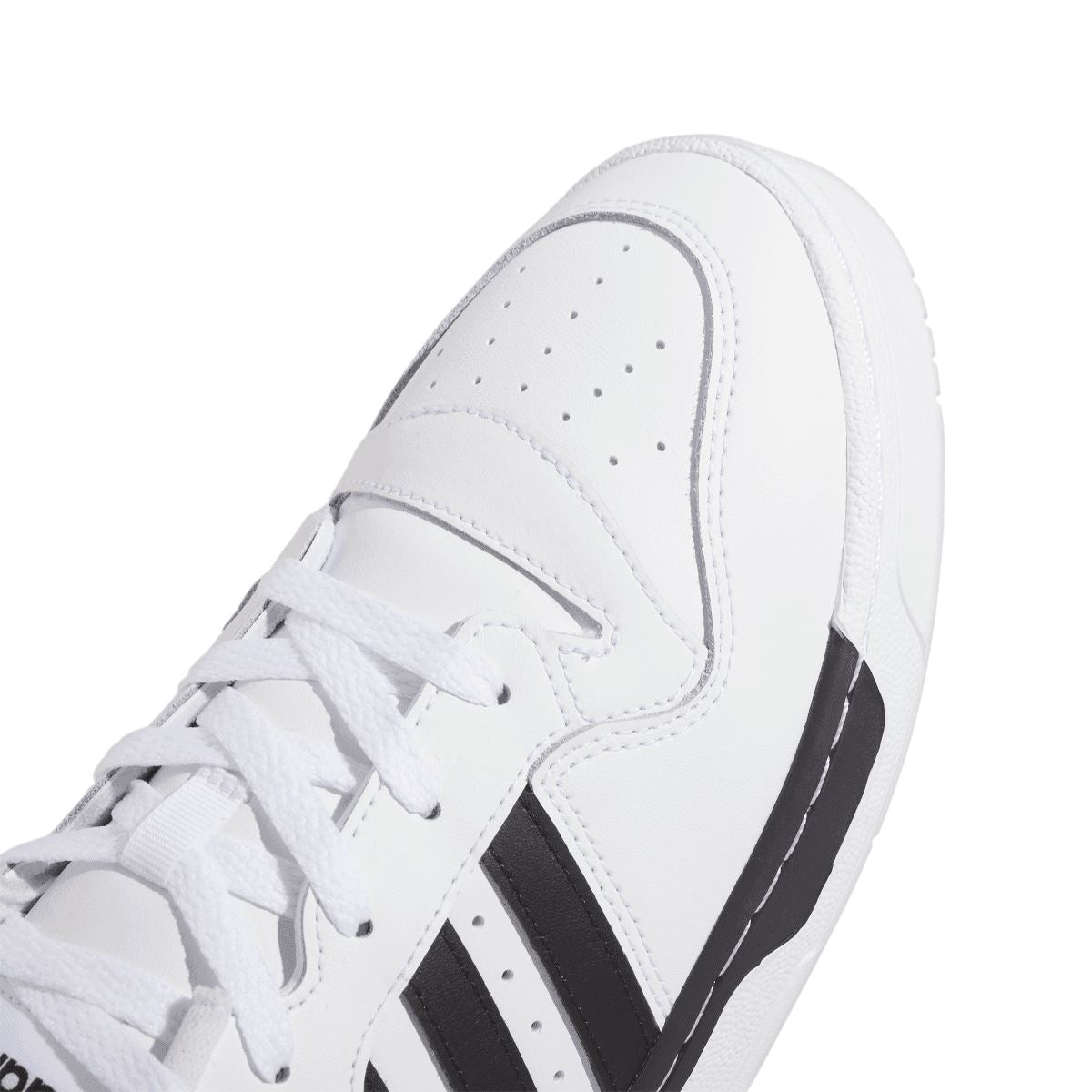 White low-top trainer upper close-up with white laces and black stripes