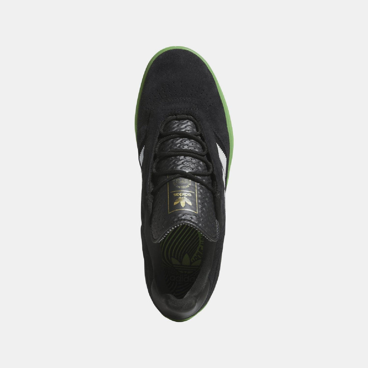 Black trainer top view with black laces, tongue label, and green outsole edge
