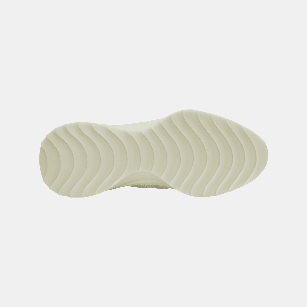 Underside of cream trainers featuring wave-pattern outsole tread